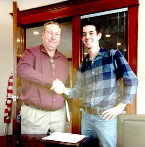 Left: Mark Reinhart, President and CEO of Award Window Cleaning seals the deal with Nate Wood right), Founder of Blue Sky Window Cleaners, LLC.